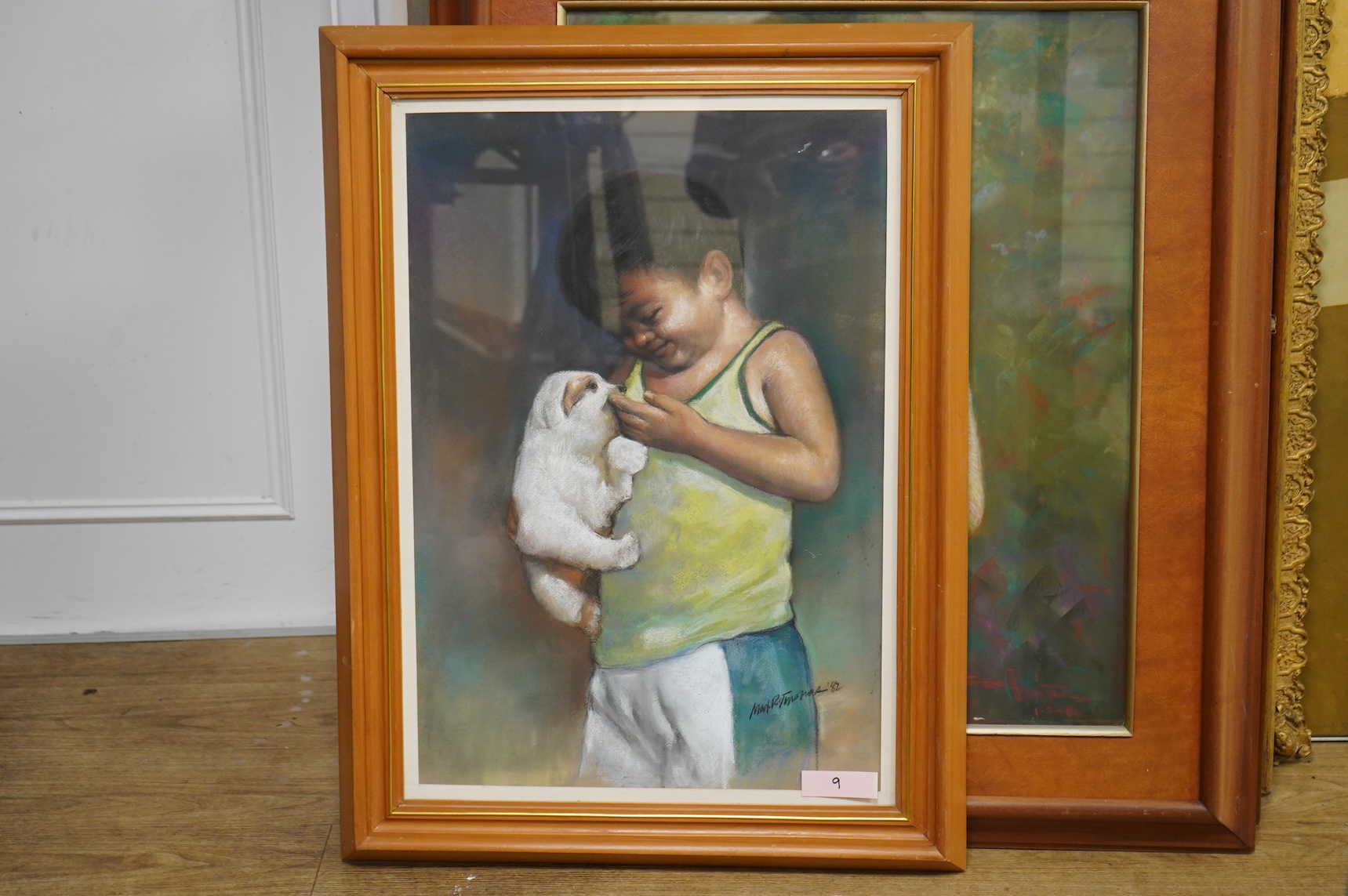 20th century, Portrait of a young Thai girl holding a puppy, indistinctly signed and dated 1981 together with a similar pastel of a young boy holding a dog, indistinctly signed and dated '82, largest 70 x 54cm